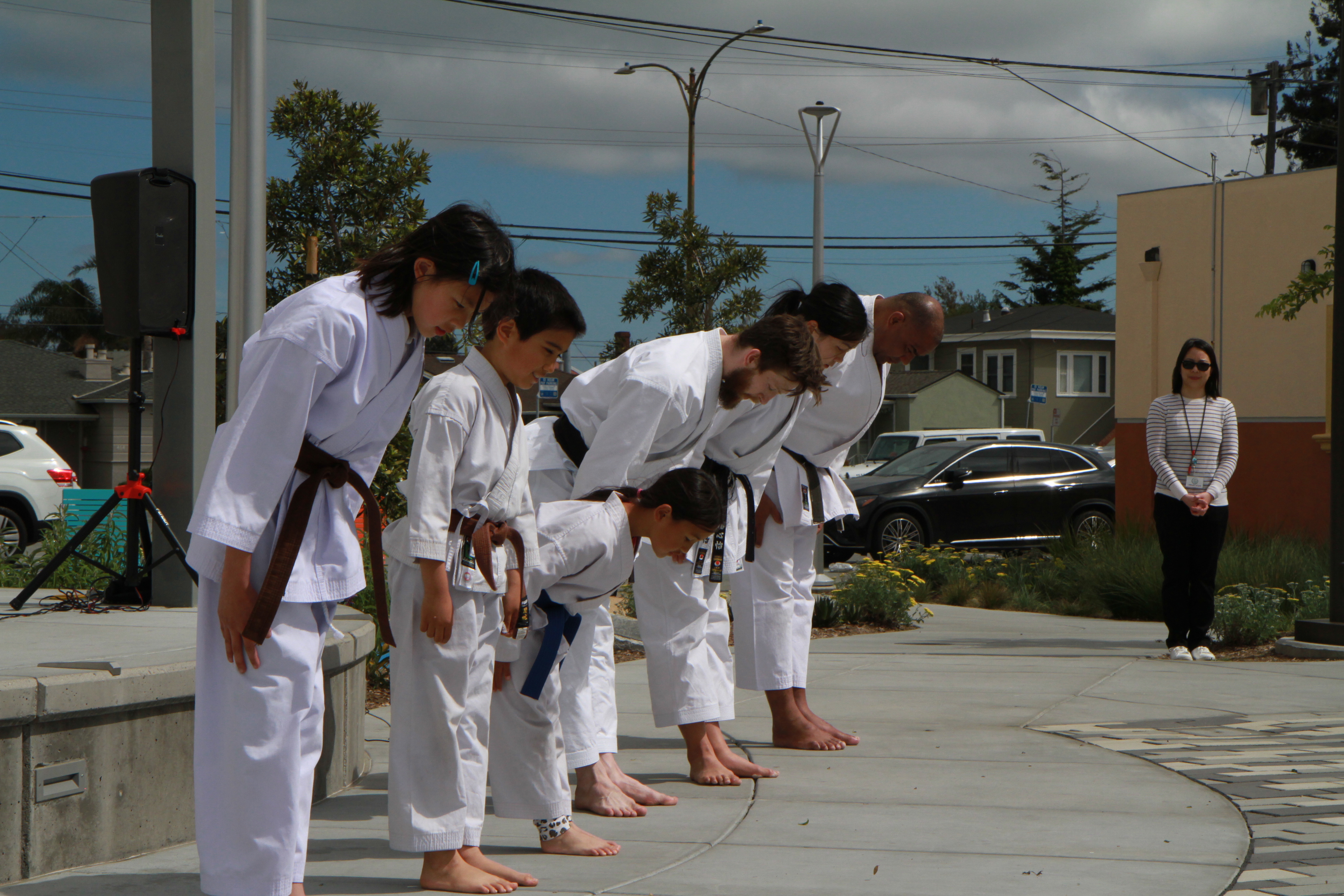 Students and instructors bowing in at an outdoor ceremony